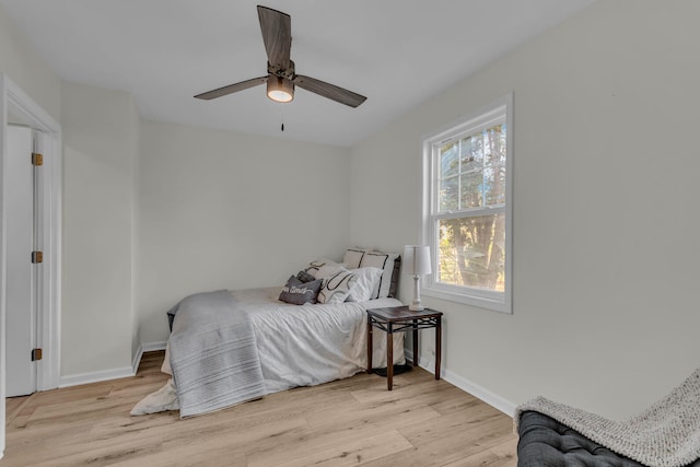 bedroom with ceiling fan and light hardwood / wood-style floors