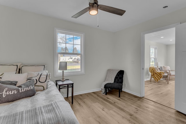 bedroom with ceiling fan and light hardwood / wood-style floors