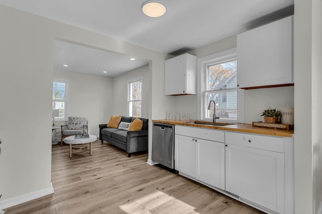 kitchen with dishwasher, light hardwood / wood-style flooring, white cabinetry, and plenty of natural light