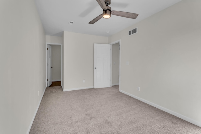 unfurnished bedroom featuring light colored carpet and ceiling fan