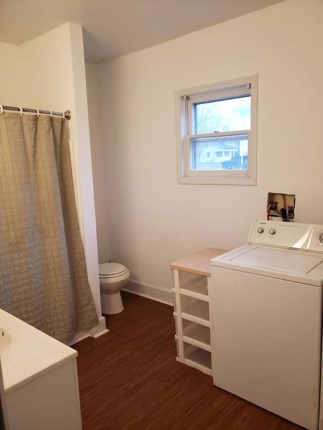 laundry area with dark hardwood / wood-style flooring and washer / clothes dryer