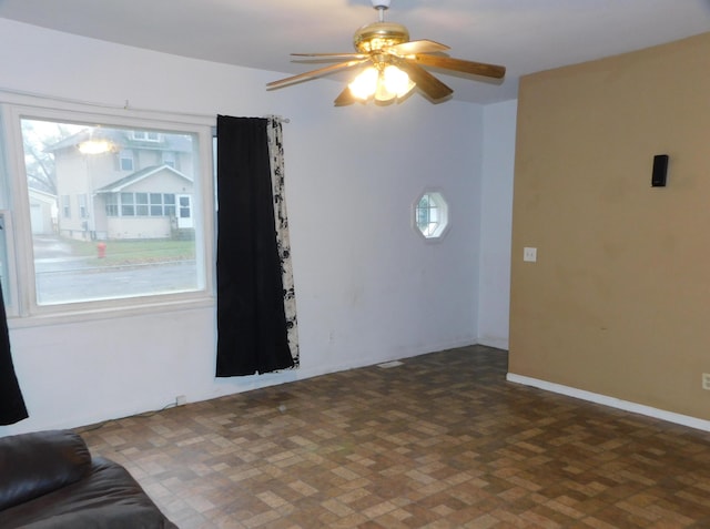 unfurnished living room featuring ceiling fan