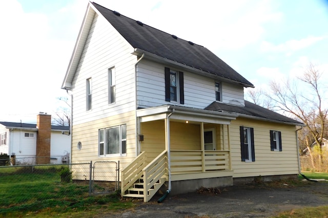 back of house featuring a porch