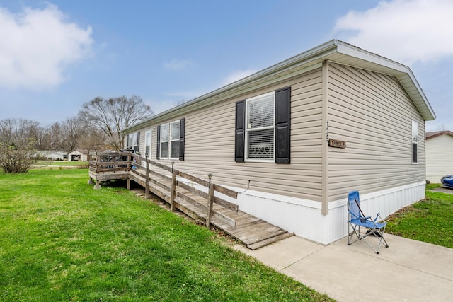 view of home's exterior with a yard and a wooden deck