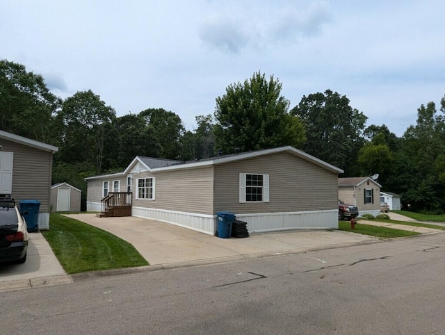 view of front facade with a front lawn and a storage unit