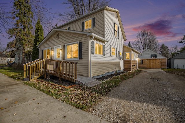 exterior space with a garage and a storage shed