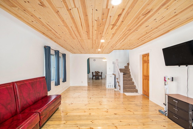 living room featuring light hardwood / wood-style floors and wooden ceiling