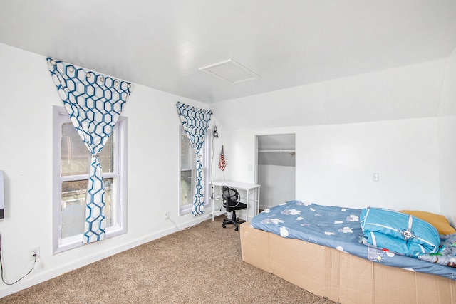 bedroom with lofted ceiling and carpet floors