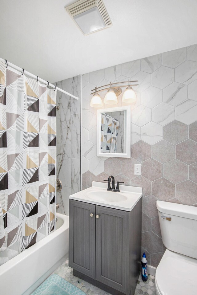 full bathroom featuring toilet, decorative backsplash, shower / tub combo with curtain, vanity, and tile walls