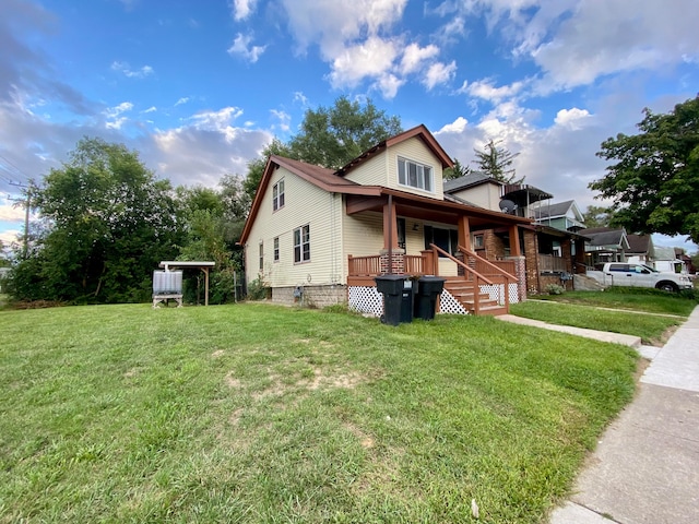 view of front of home with covered porch and a front yard