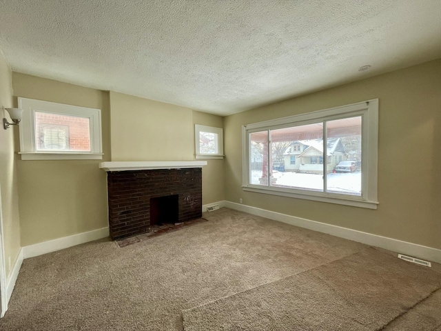 unfurnished living room featuring a fireplace, carpet, and a textured ceiling