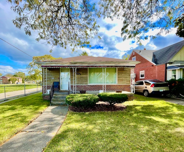 bungalow-style home featuring a front yard and a porch