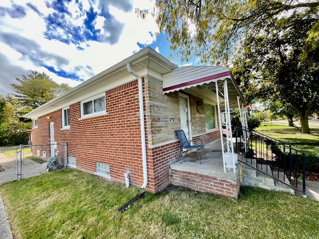 view of side of home with a lawn