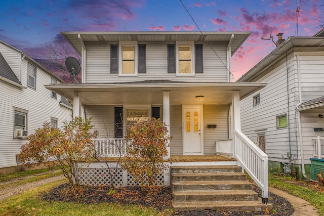 view of front of property with a porch and cooling unit