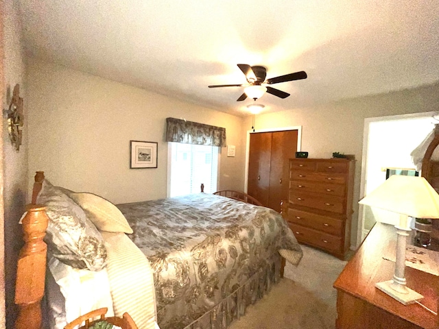 bedroom with light carpet, a textured ceiling, a closet, and ceiling fan