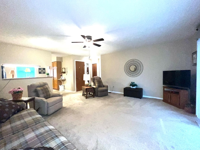 carpeted living room featuring ceiling fan