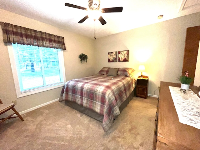 bedroom with light colored carpet and ceiling fan