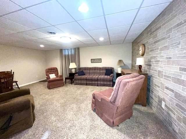 carpeted living room featuring a drop ceiling