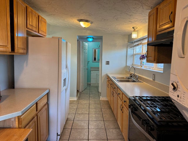 kitchen with ventilation hood, sink, hanging light fixtures, white fridge with ice dispenser, and a textured ceiling