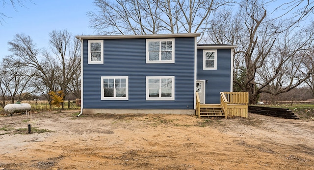 rear view of property featuring a deck