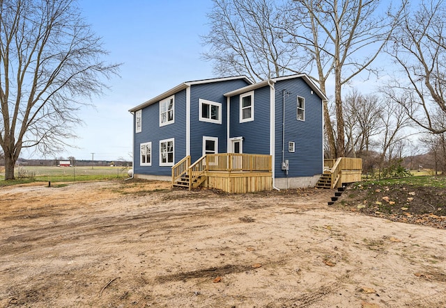 back of property featuring a wooden deck