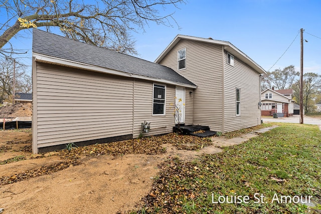 view of side of home featuring a lawn