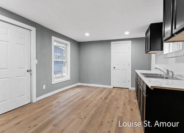 kitchen featuring light wood-type flooring and sink