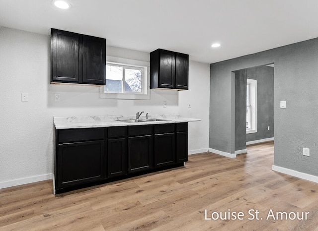 kitchen with sink and light hardwood / wood-style flooring