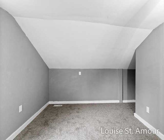 bonus room featuring carpet flooring and lofted ceiling