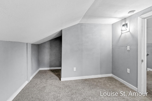 bonus room with carpet, a textured ceiling, and vaulted ceiling