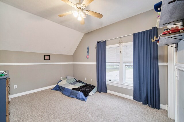 carpeted bedroom with ceiling fan and lofted ceiling