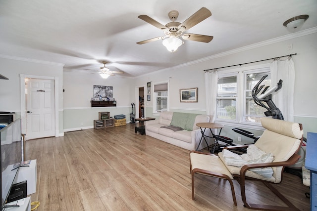 living room with ceiling fan, crown molding, and light hardwood / wood-style flooring