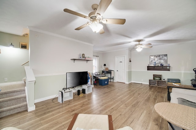 living room with ceiling fan, crown molding, and light wood-type flooring