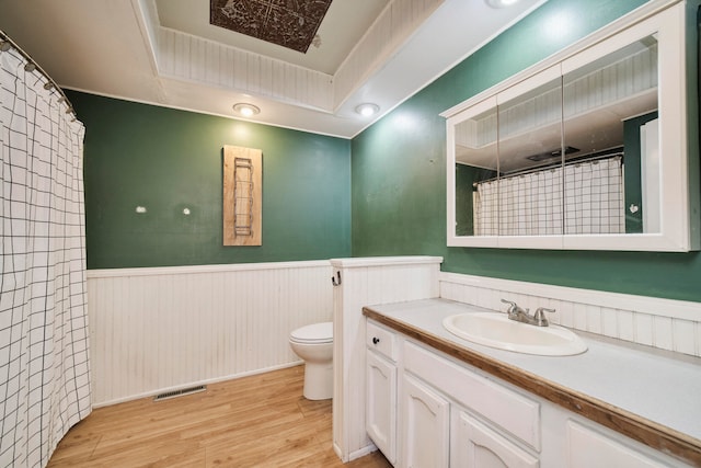 bathroom with hardwood / wood-style floors, vanity, and toilet