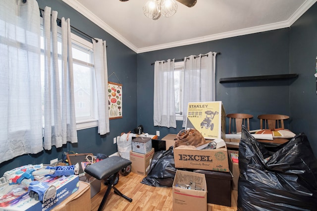 bedroom with wood-type flooring, ornamental molding, and multiple windows