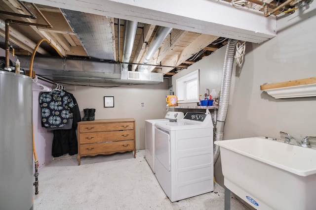 washroom with washing machine and clothes dryer, water heater, and sink