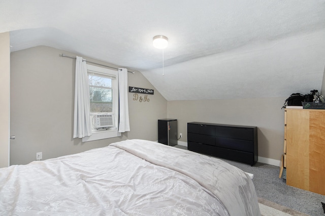 carpeted bedroom with a textured ceiling and vaulted ceiling