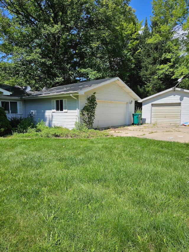 exterior space with an outbuilding, a front lawn, and a garage