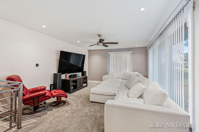 living room with ceiling fan and carpet floors