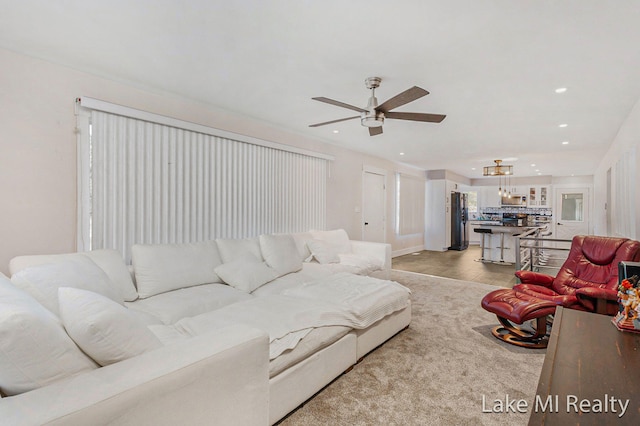 living room with ceiling fan and light colored carpet