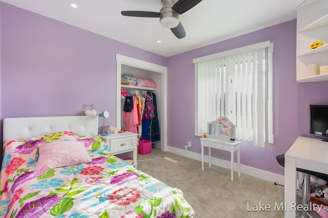 carpeted bedroom with ceiling fan, multiple windows, and a closet