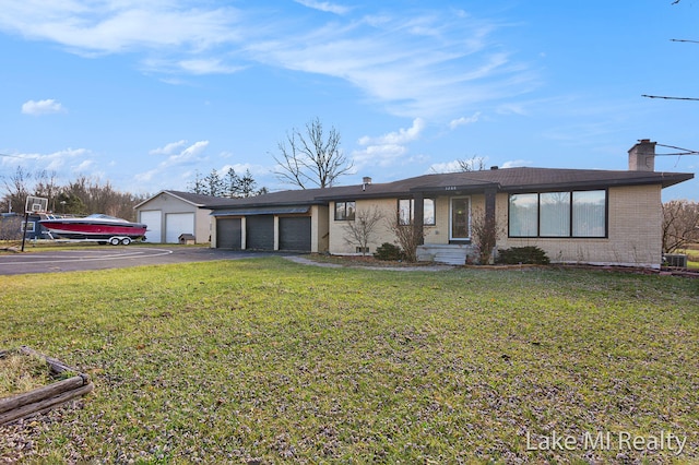 single story home featuring a front lawn and a garage