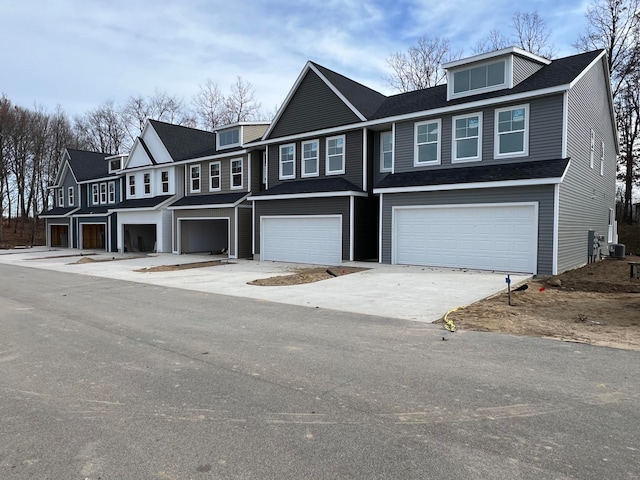 view of front facade featuring central AC unit and a garage