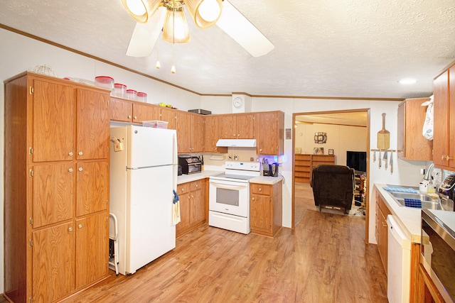 kitchen featuring white appliances, vaulted ceiling, light hardwood / wood-style flooring, ornamental molding, and a textured ceiling