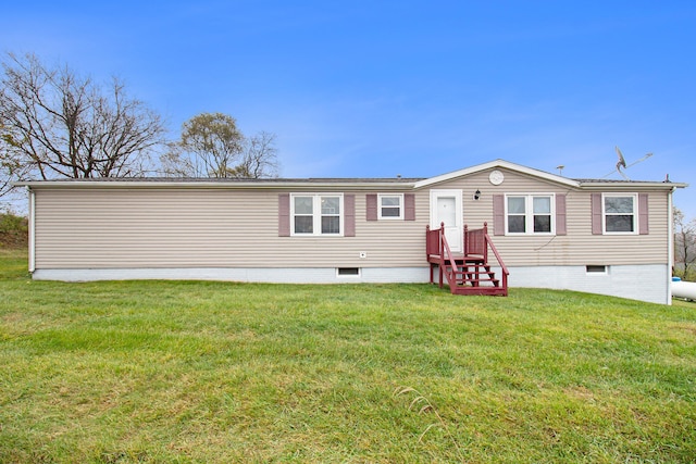 back of house with a lawn