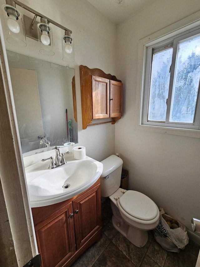 bathroom featuring tile patterned flooring, vanity, and toilet