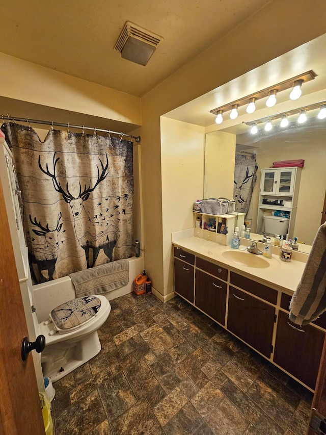 full bathroom featuring shower / bath combination with curtain, toilet, and vanity