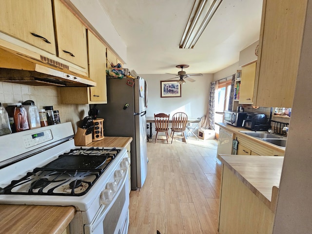 kitchen with ceiling fan, light brown cabinets, white range with gas stovetop, light hardwood / wood-style floors, and decorative backsplash