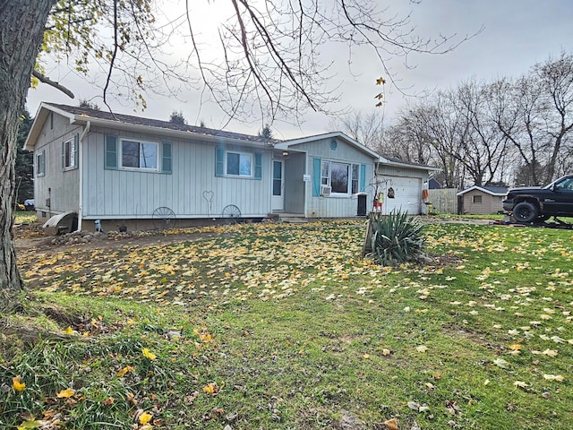 view of front of property with a front yard and a garage