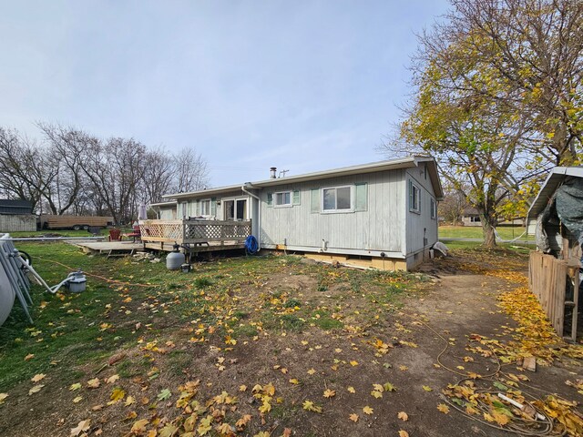 rear view of house featuring a deck